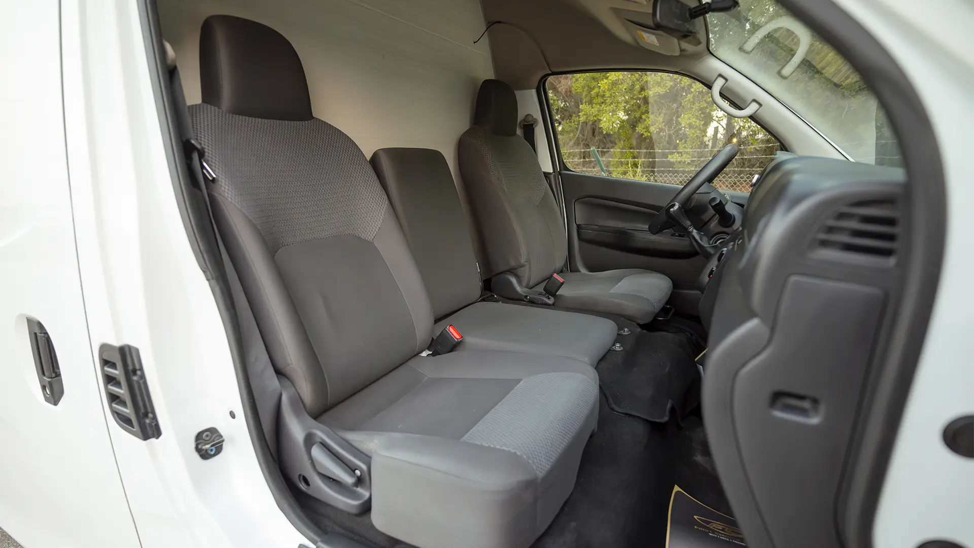 Used 2023 Nissan Urvan High Roof in White – Front Passenger Side Cabin View for Sale at First Choice Cars Dubai Sharjah