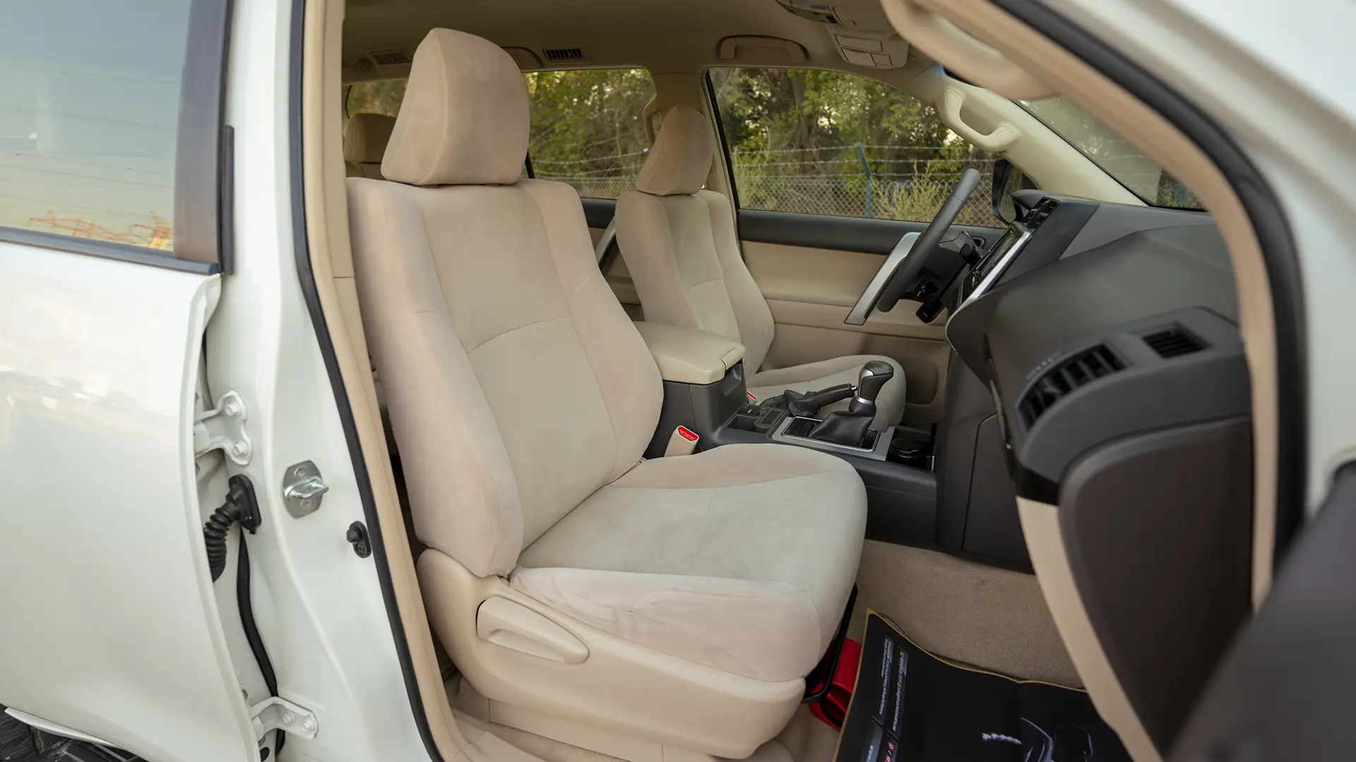 Used 2022 Toyota Prado EXR in White – Front Passenger Side Cabin View for Sale at First Choice Cars Dubai Sharjah