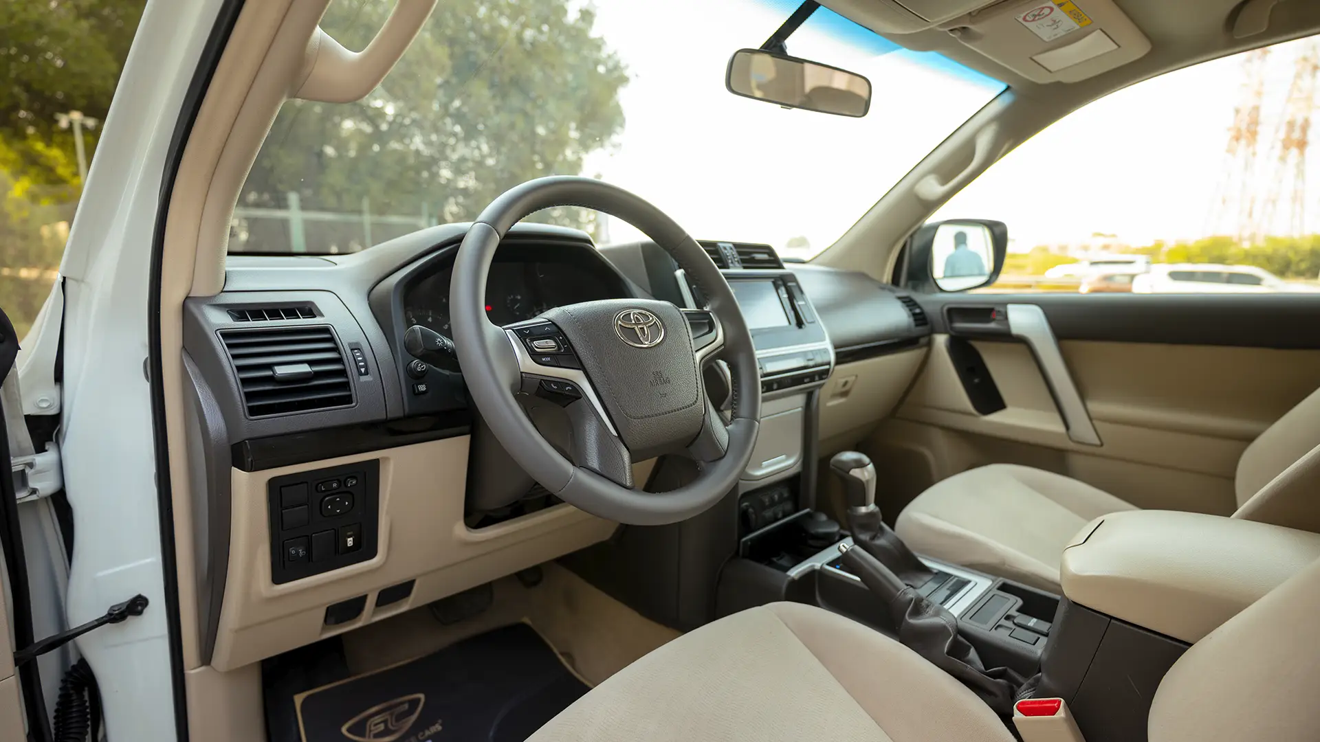 Used 2022 Toyota Prado EXR in White – Driver Side Dashboard & Steering View for Sale at First Choice Cars Dubai Sharjah