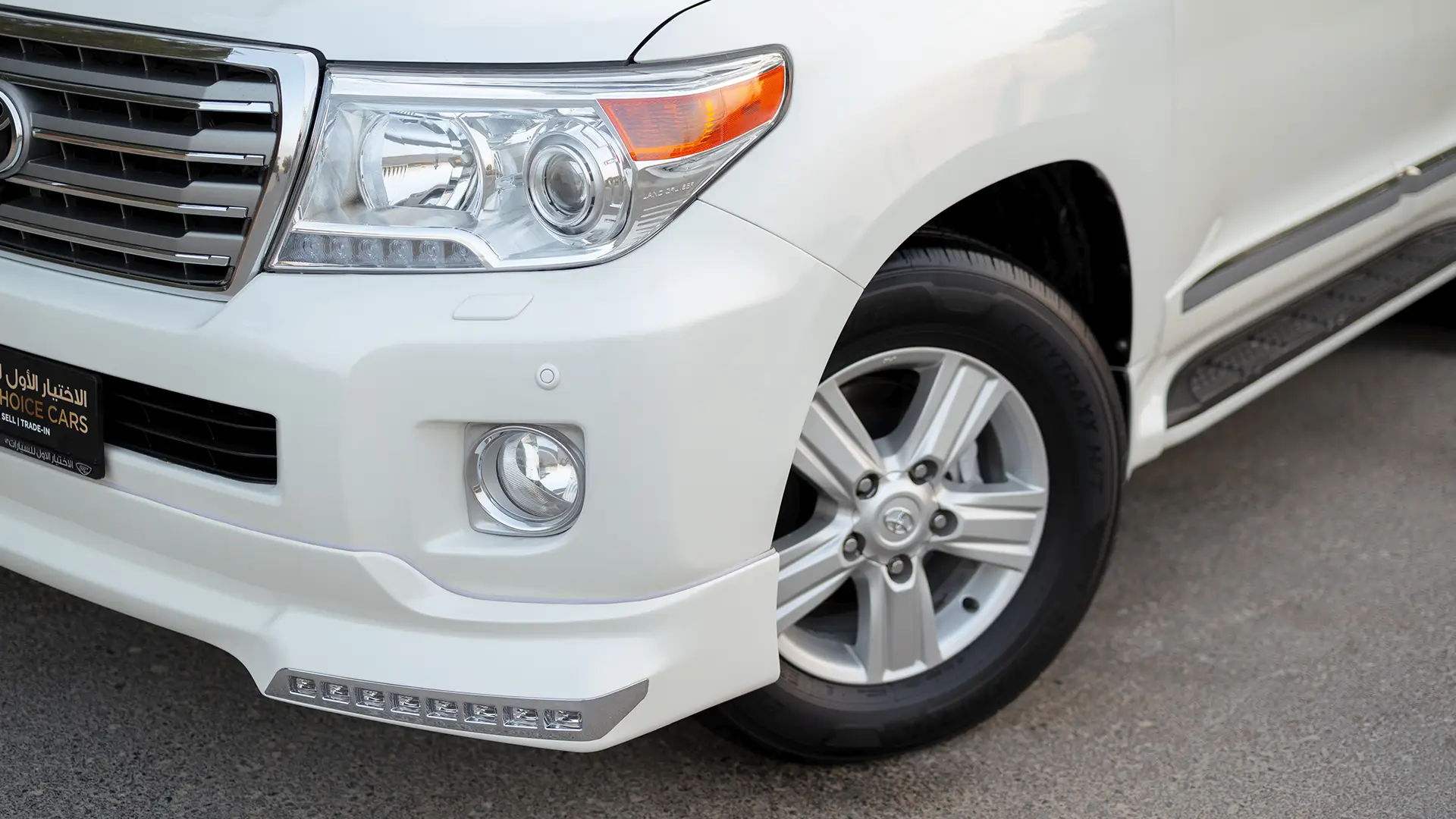 Used 2014 Toyota Land Cruiser VXR in White – Headlight Close-up for Sale at First Choice Cars Dubai Sharjah