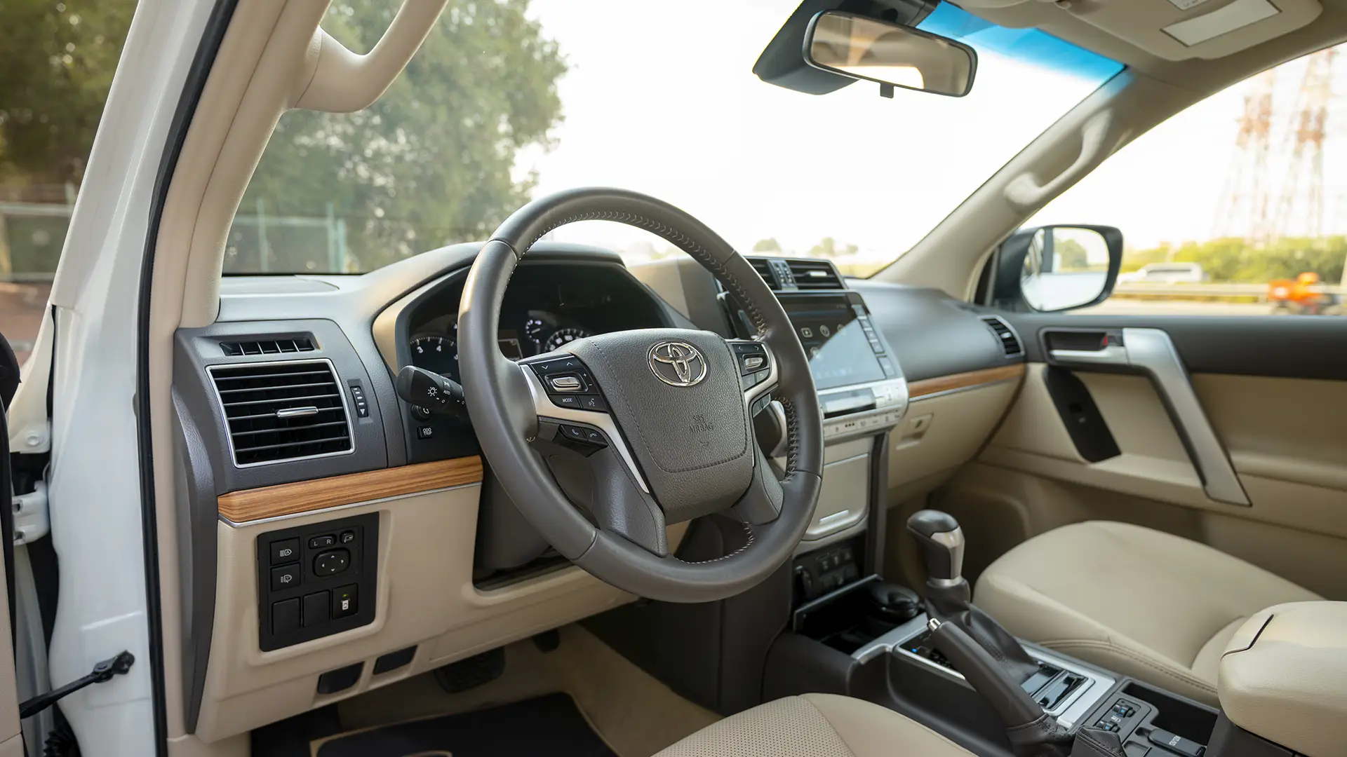 Used 2023 Toyota Prado VXR in White – Driver Side Dashboard & Steering View for Sale at First Choice Cars Dubai Sharjah