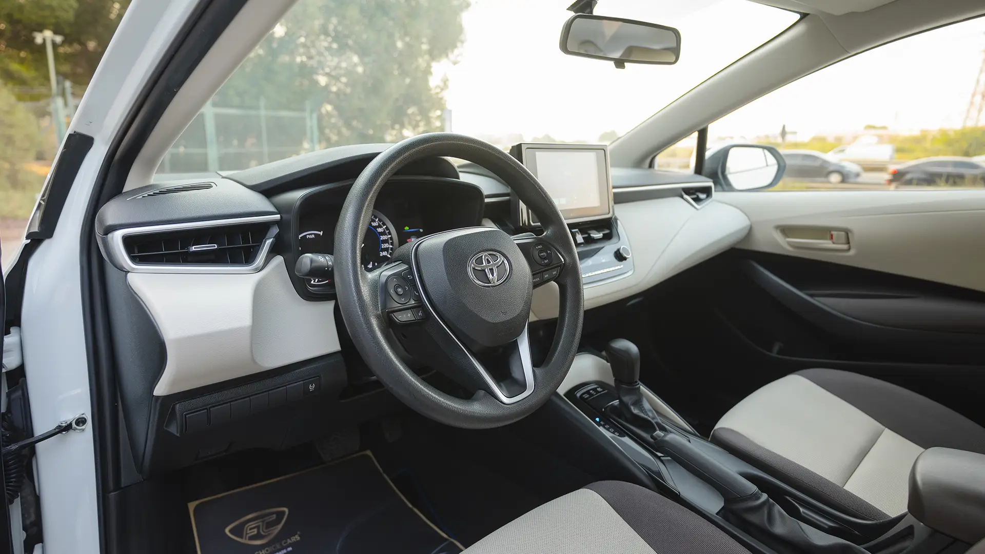 Used 2024 Toyota Corolla XLI in White – Driver Side Dashboard & Steering View for Sale at First Choice Cars Dubai Sharjah