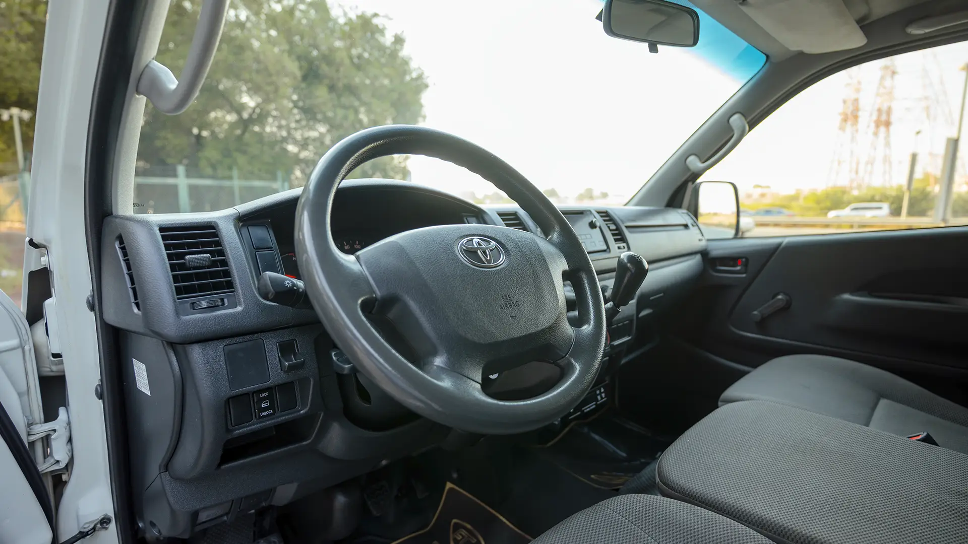 Used 2022 Toyota Hiace GL Standard Roof in White – Driver Side Dashboard & Steering View for Sale at First Choice Cars Dubai Sharjah