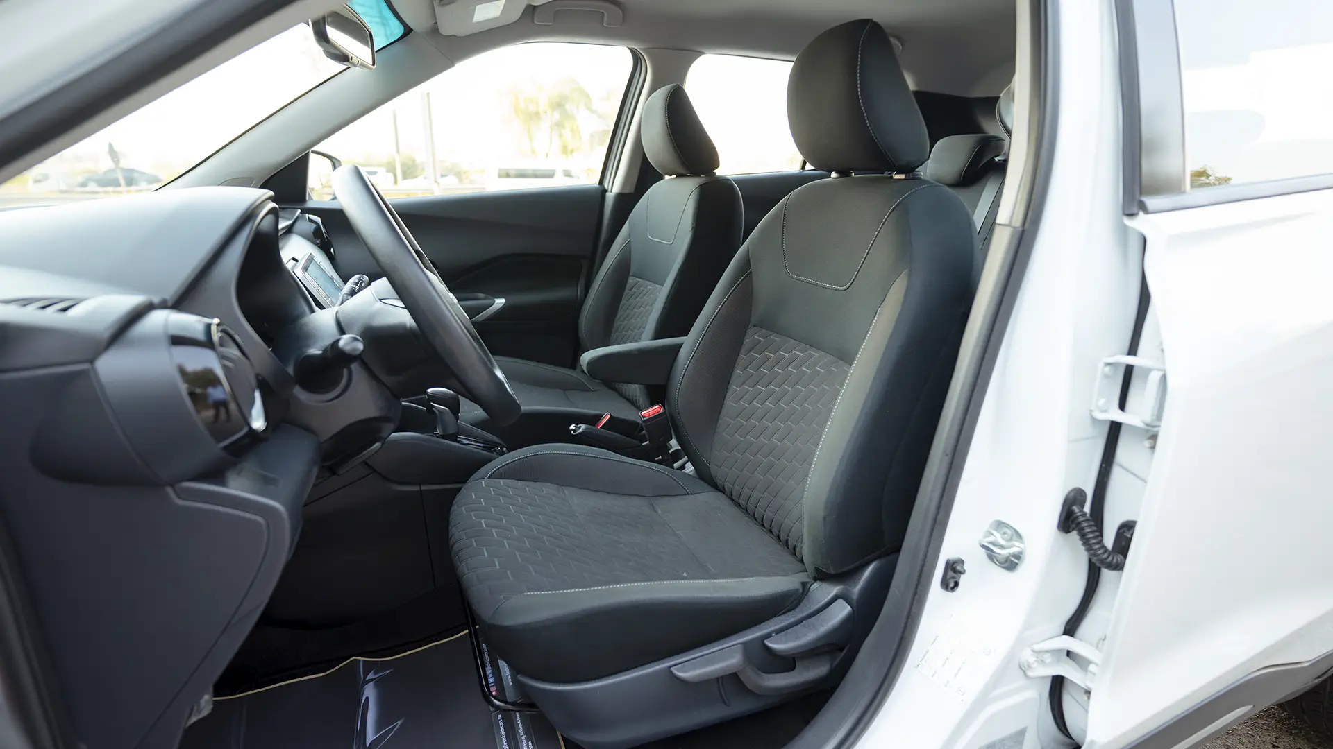 Used 2024 Nissan Kicks SV in White – Front Driver Side Cabin View for Sale at First Choice Cars Dubai Sharjah
