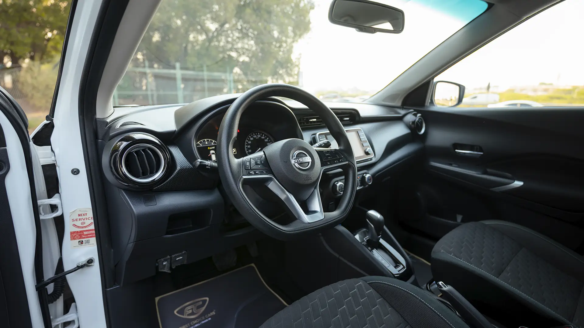 Used 2024 Nissan Kicks SV in White – Driver Side Dashboard & Steering View for Sale at First Choice Cars Dubai Sharjah