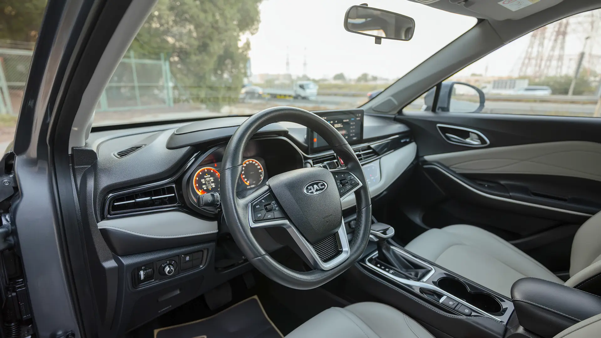 Used 2023 JAC JS4 Intelligent in Grey – Driver Side Dashboard & Steering View for Sale at First Choice Cars Dubai Sharjah