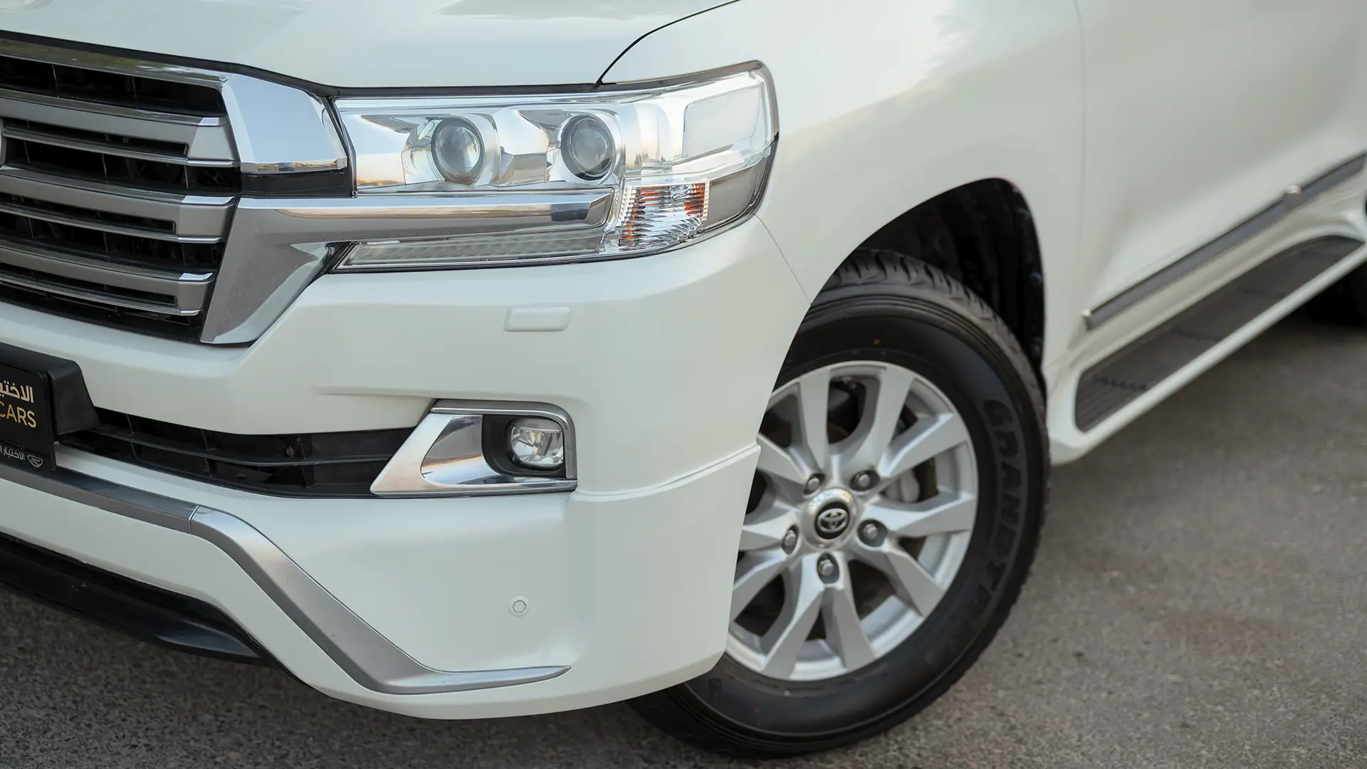 Used 2017 Toyota Land Cruiser GXR in White – Headlight Close-up for Sale at First Choice Cars Dubai Sharjah