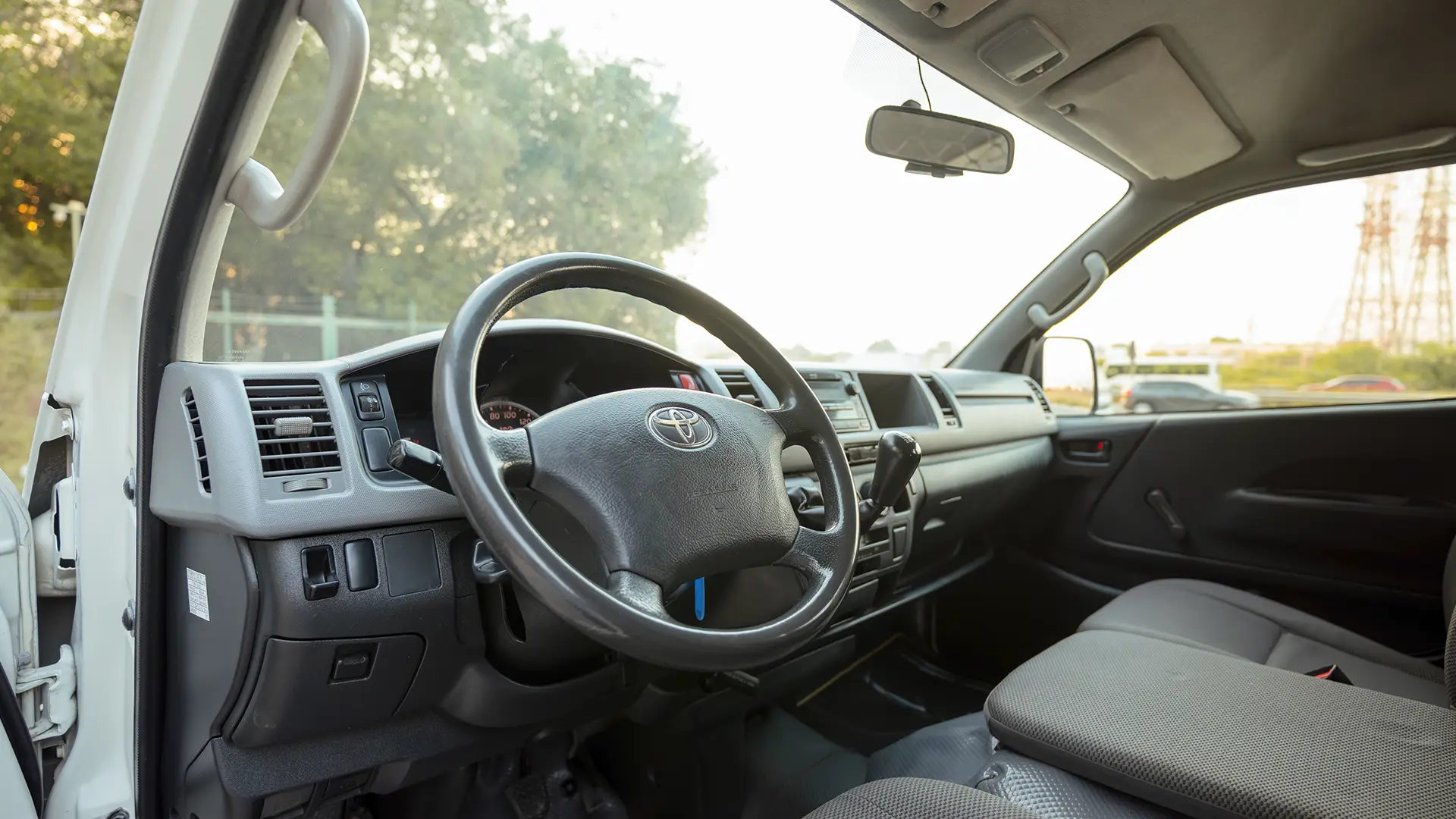 Used 2012 Toyota Hiace GL High Roof in White – Driver Side Dashboard & Steering View for Sale at First Choice Cars Dubai Sharjah