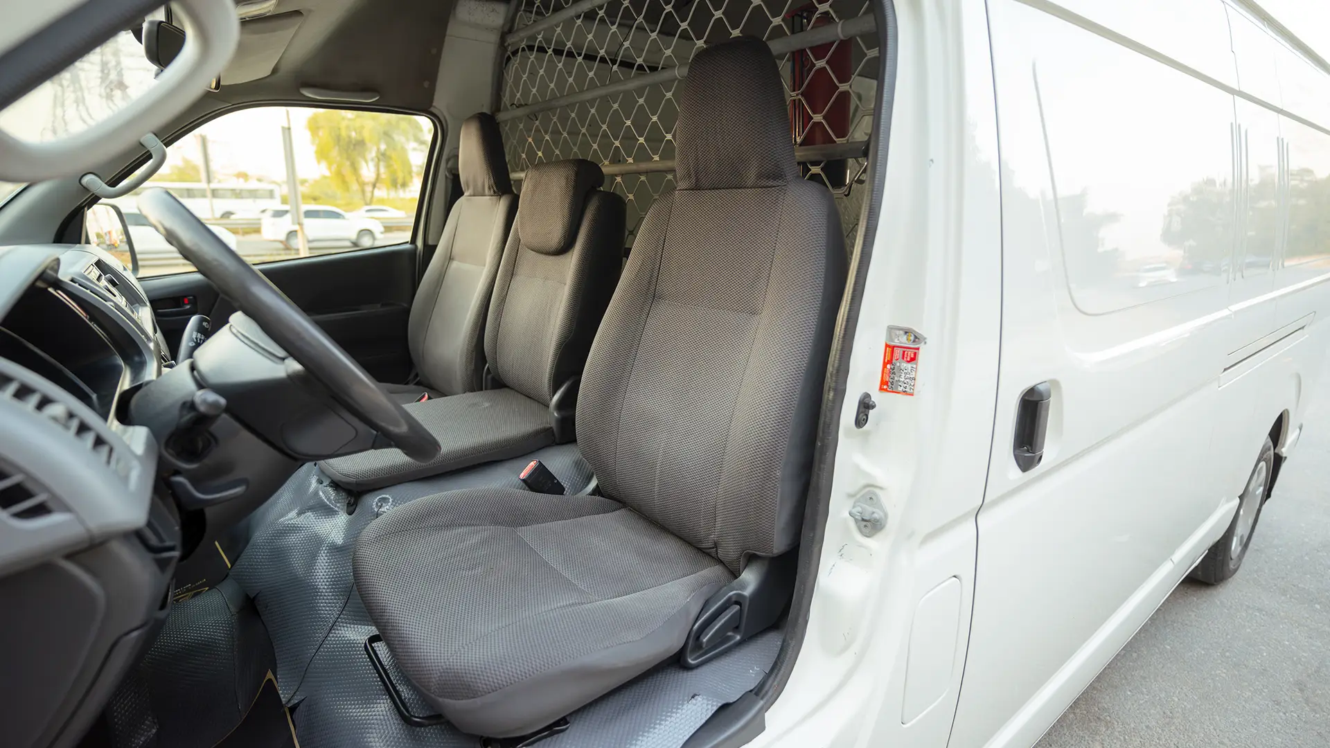 Used 2012 Toyota Hiace GL High Roof in White – Front Driver Side Cabin View for Sale at First Choice Cars Dubai Sharjah