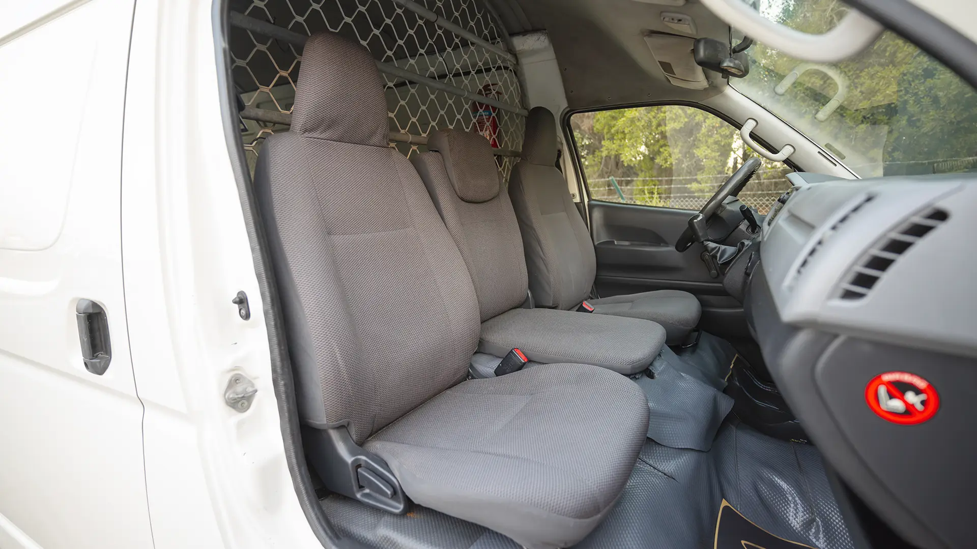Used 2012 Toyota Hiace GL High Roof in White – Front Passenger Side Cabin View for Sale at First Choice Cars Dubai Sharjah