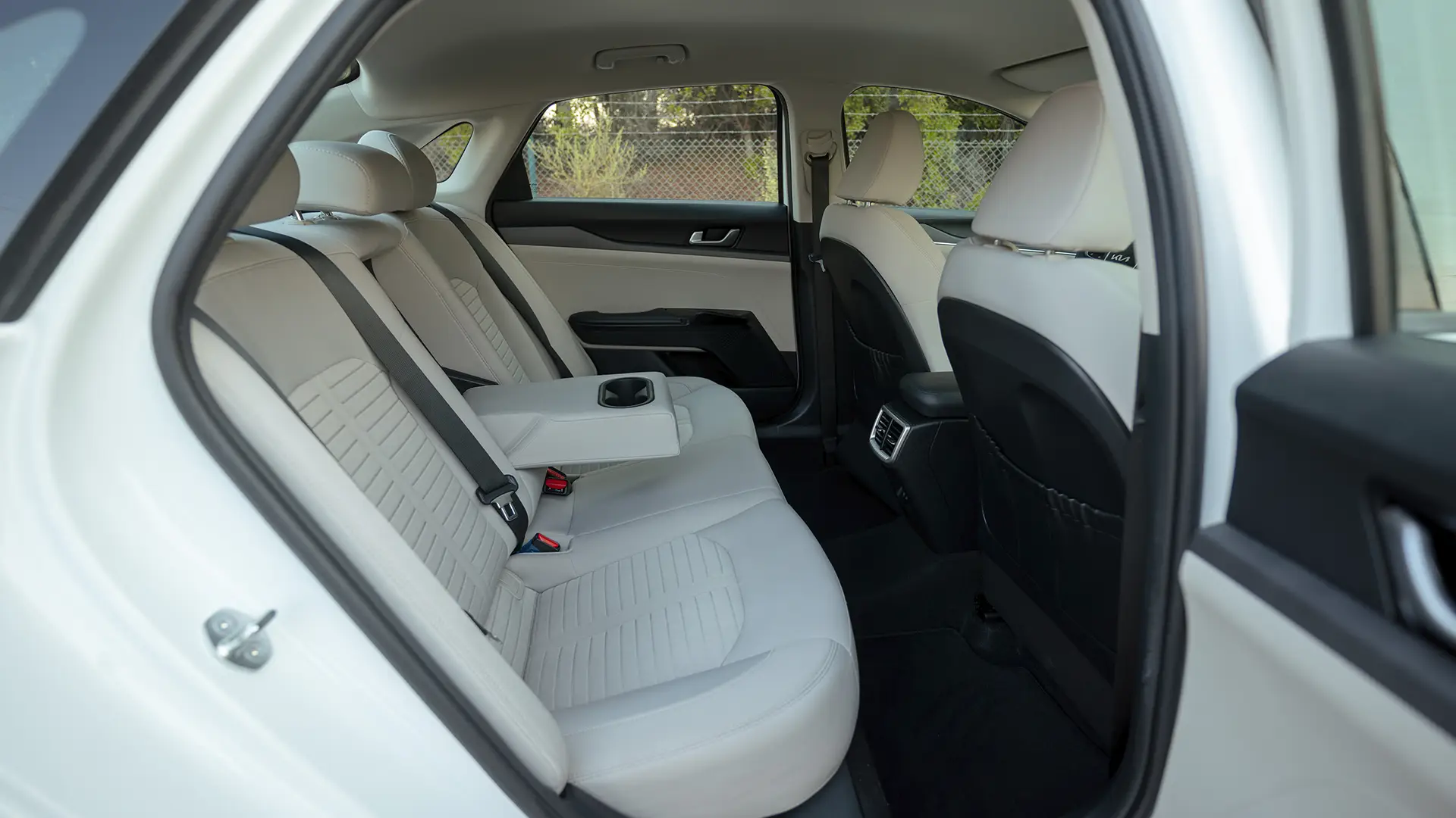 Used 2023 Kia K5 EX in White – Rear Passenger Side Cabin View for Sale at First Choice Cars Dubai Sharjah