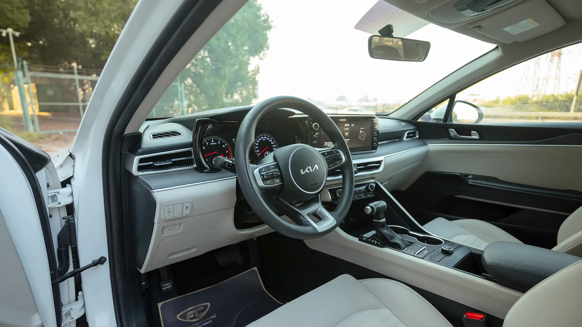 Used 2023 Kia K5 EX in White – Driver Side Dashboard & Steering View for Sale at First Choice Cars Dubai Sharjah