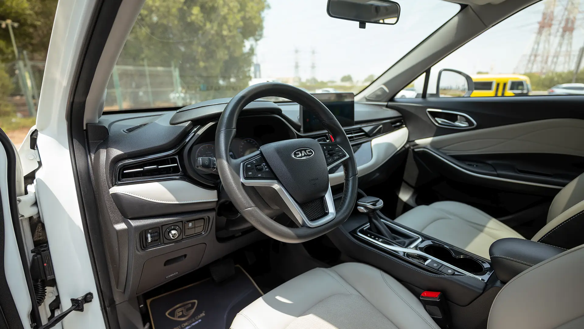 Used 2023 JAC JS4 Intelligent in White – Driver Side Dashboard & Steering View for Sale at First Choice Cars Dubai Sharjah
