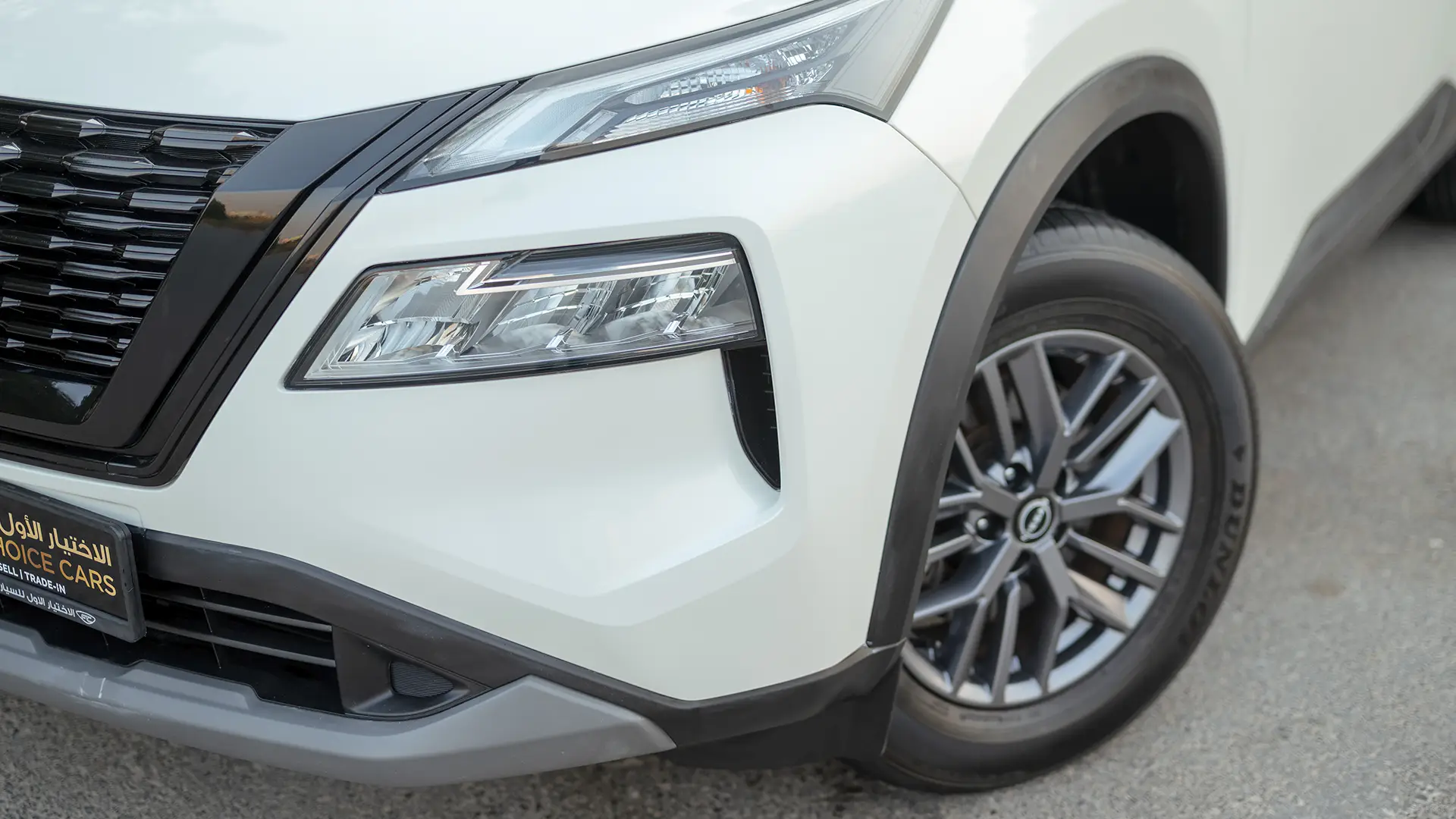 Used 2024 Nissan X-Trail S in White – Headlight Close-up for Sale at First Choice Cars Dubai Sharjah