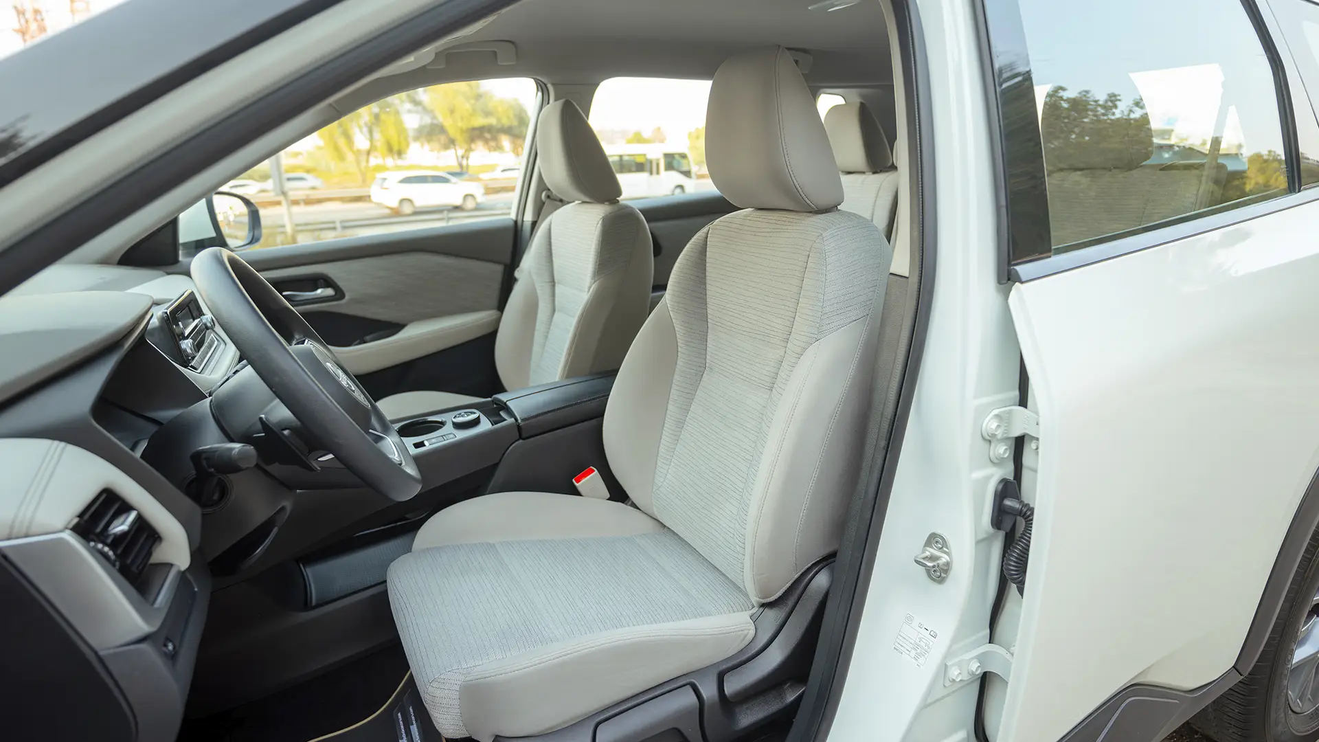 Used 2024 Nissan X-Trail S in White – Front Driver Side Cabin View for Sale at First Choice Cars Dubai Sharjah