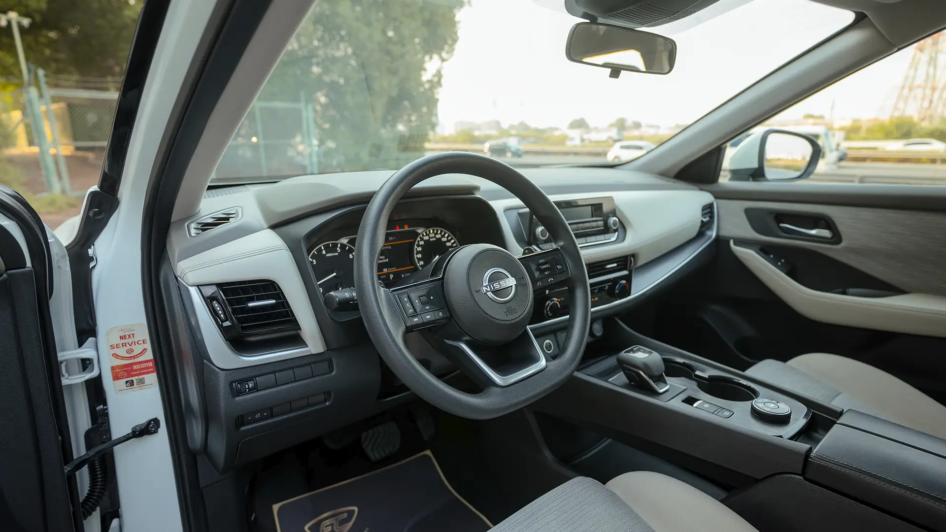 Used 2024 Nissan X-Trail S in White – Driver Side Dashboard & Steering View for Sale at First Choice Cars Dubai Sharjah