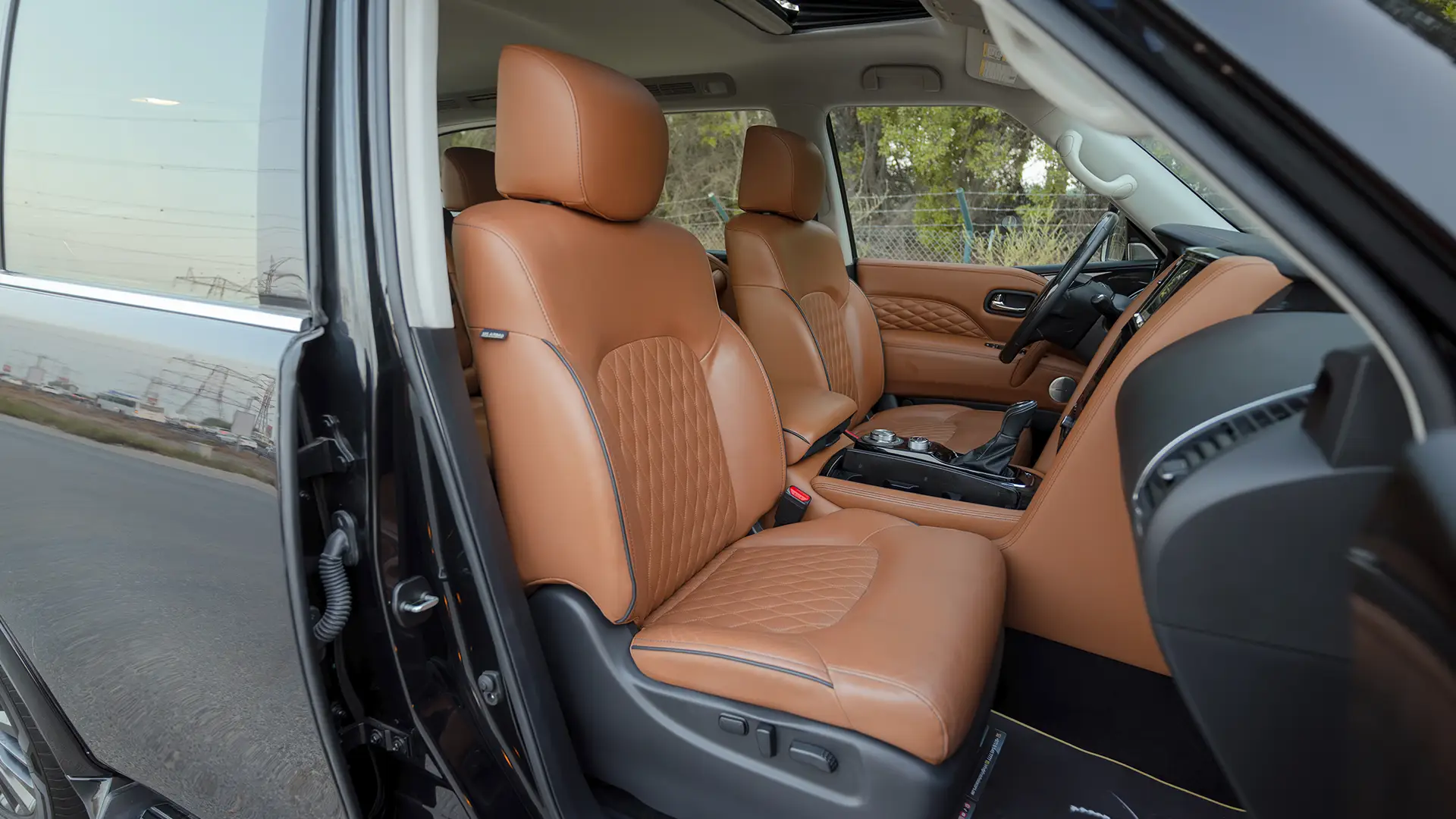 Used 2021 Infiniti QX80 Sensory in Black – Front Passenger Side Cabin View for Sale at First Choice Cars Dubai Sharjah