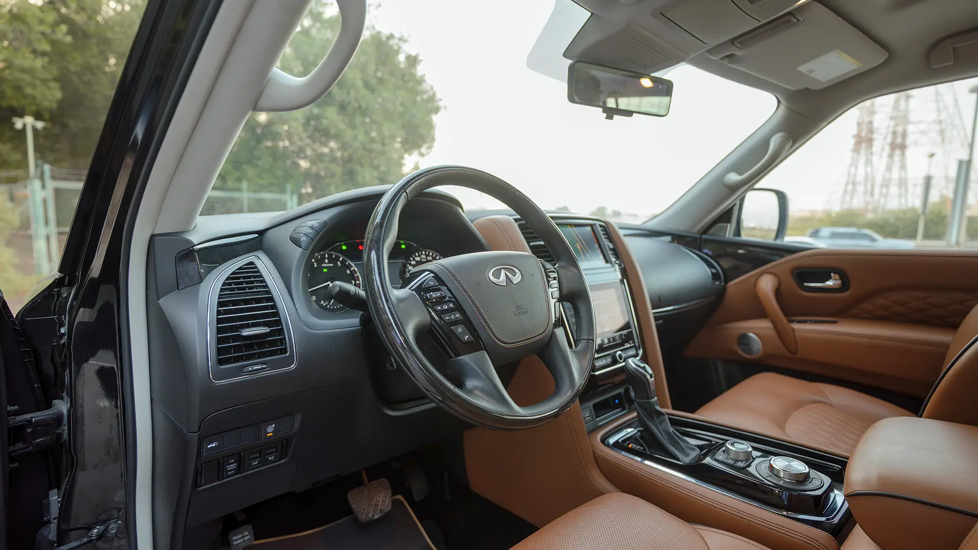 Used 2021 Infiniti QX80 Sensory in Black – Driver Side Dashboard & Steering View for Sale at First Choice Cars Dubai Sharjah