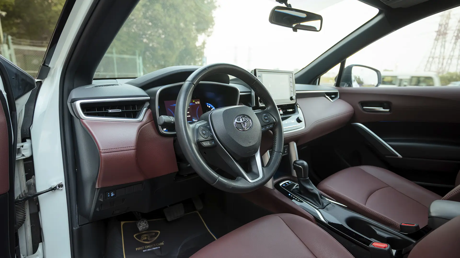 Used 2022 Toyota Corolla Cross GLi in White – Driver Side Dashboard & Steering View for Sale at First Choice Cars Dubai Sharjah