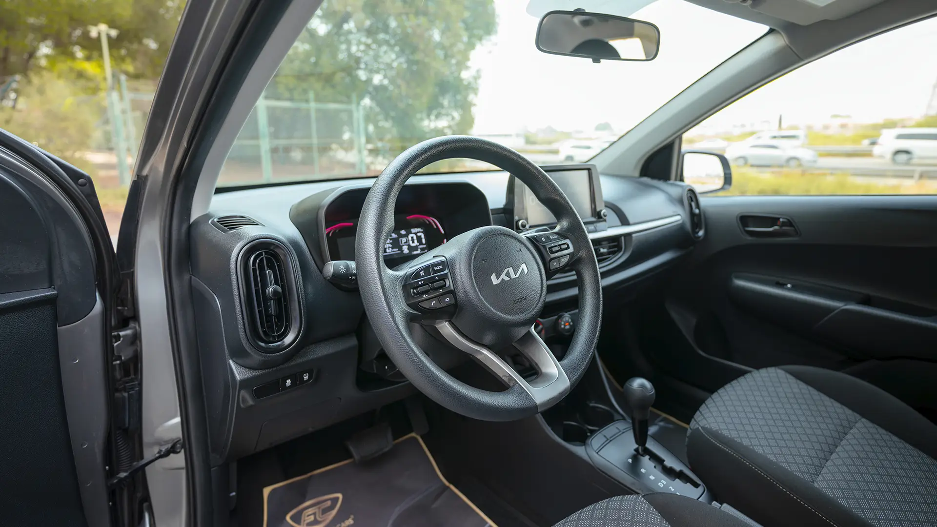 Used 2024 Kia Picanto LX in Grey – Driver Side Dashboard & Steering View for Sale at First Choice Cars Dubai Sharjah