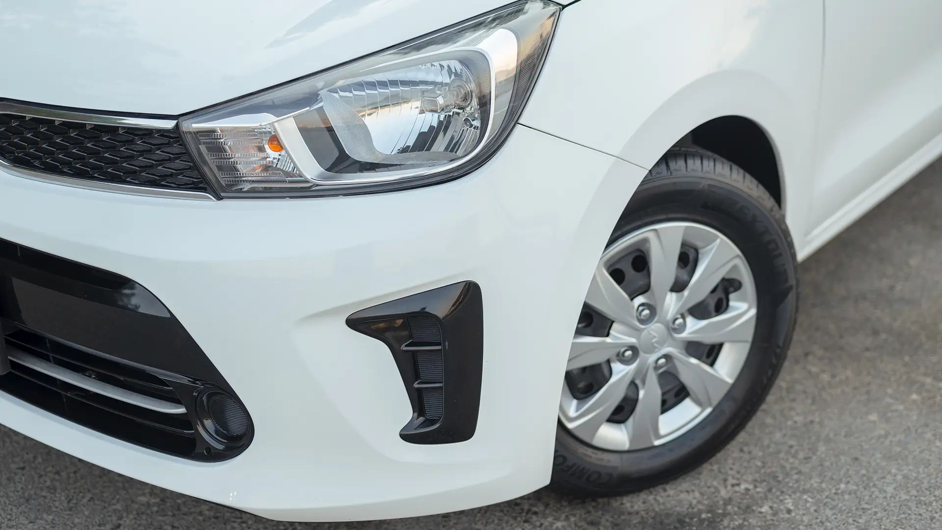 Used 2024 Kia Pegas EX in White – Headlight Close-up for Sale at First Choice Cars Dubai Sharjah