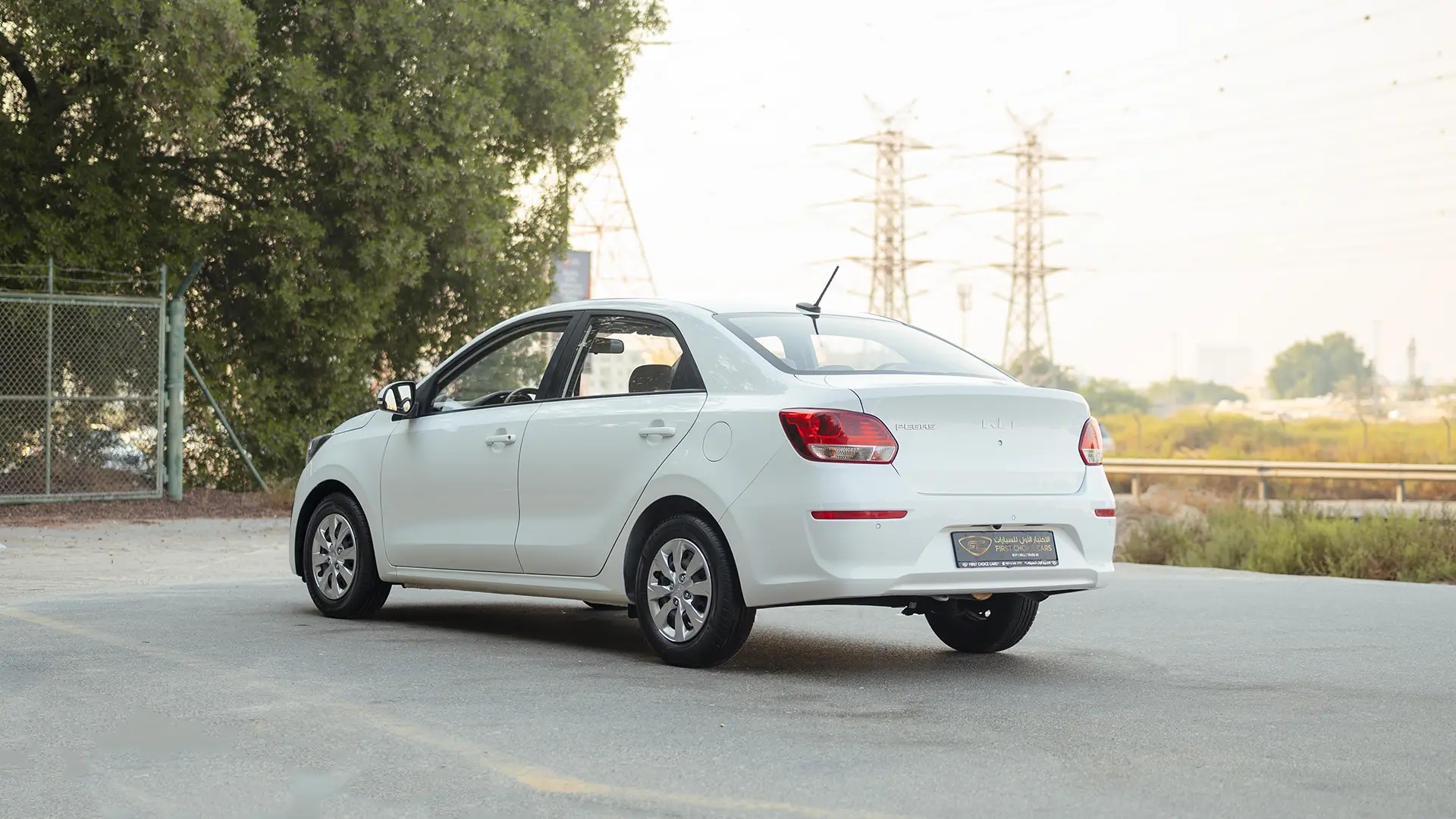 Used 2024 Kia Pegas EX in White – Left Back Diagonal (45°) View for Sale at First Choice Cars Dubai Sharjah