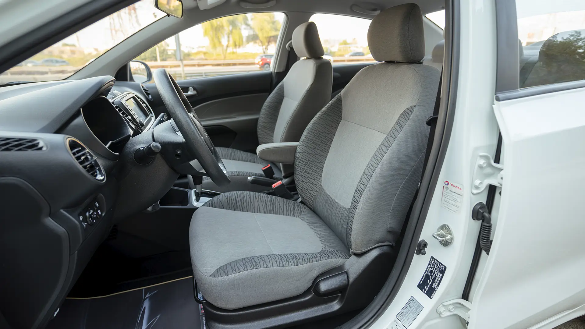 Used 2024 Kia Pegas EX in White – Front Driver Side Cabin View for Sale at First Choice Cars Dubai Sharjah