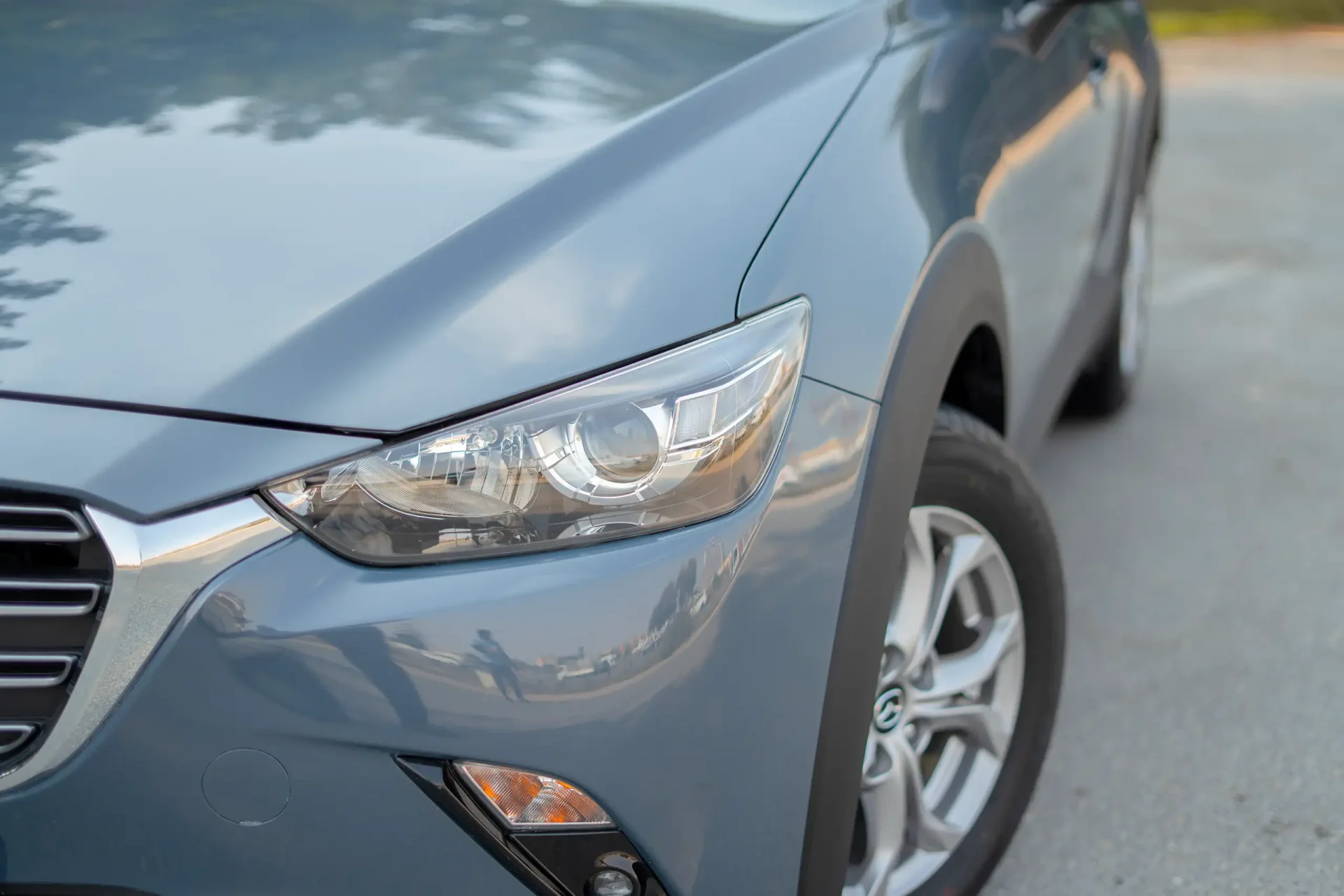 Used 2023 Mazda CX-3 GS in Blue – Headlight Close-up for Sale at First Choice Cars Dubai Sharjah