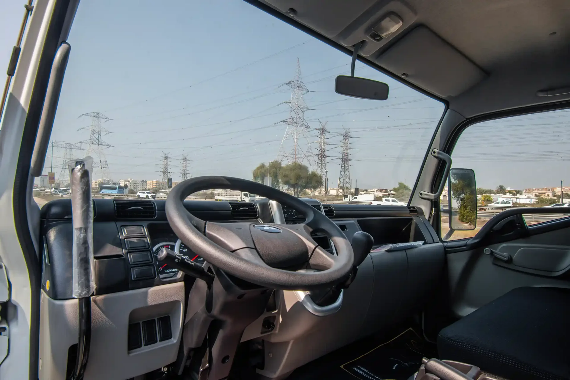 Used 2024 Mitsubishi Canter Tipper in White – Driver Side Dashboard & Steering View for Sale at First Choice Cars Dubai Sharjah