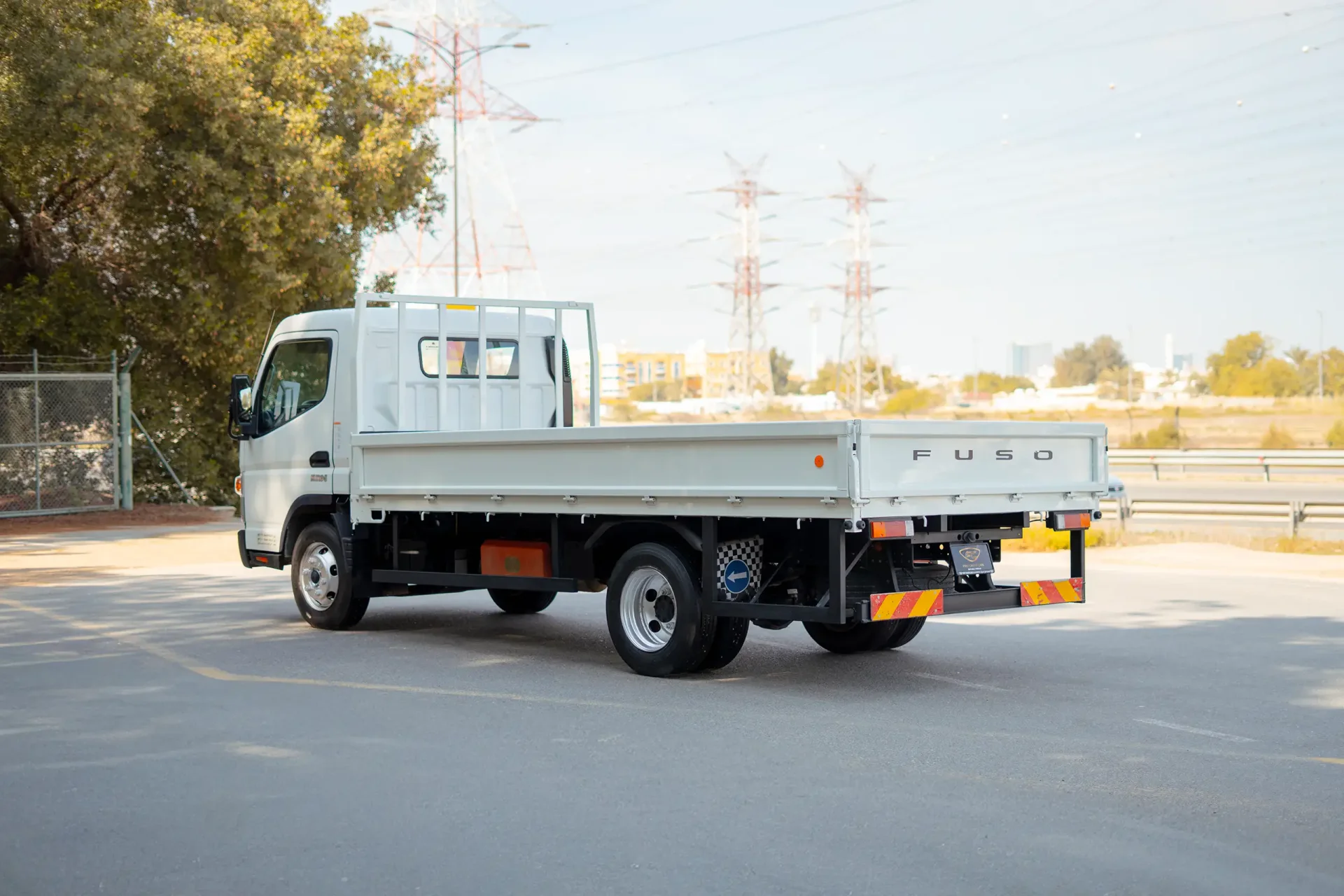 Used 2023 Mitsubishi Canter Cargo Body in White – Left Back Diagonal (45°) View for Sale at First Choice Cars Dubai Sharjah