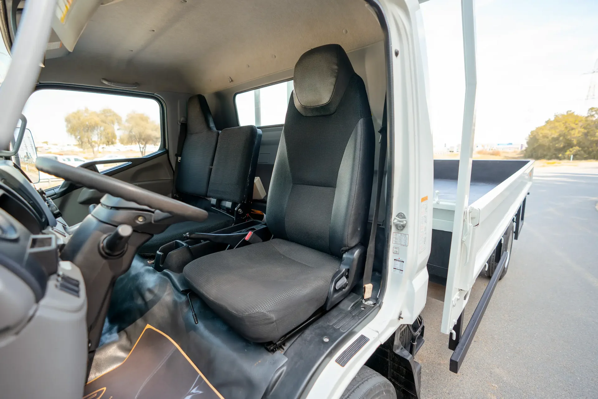 Used 2023 Mitsubishi Canter Cargo Body in White – Front Driver Side Cabin View for Sale at First Choice Cars Dubai Sharjah