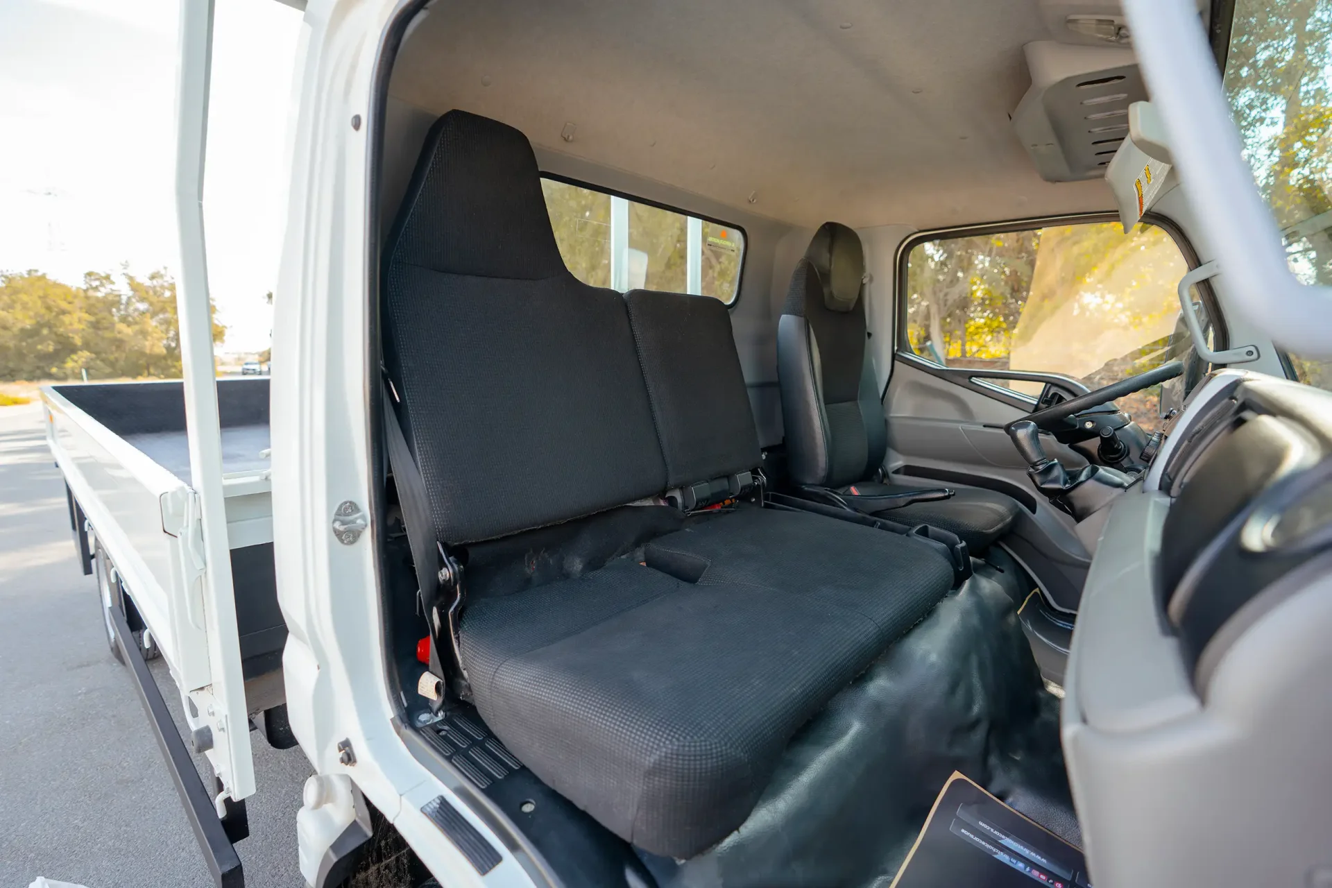 Used 2023 Mitsubishi Canter Cargo Body in White – Front Passenger Side Cabin View for Sale at First Choice Cars Dubai Sharjah