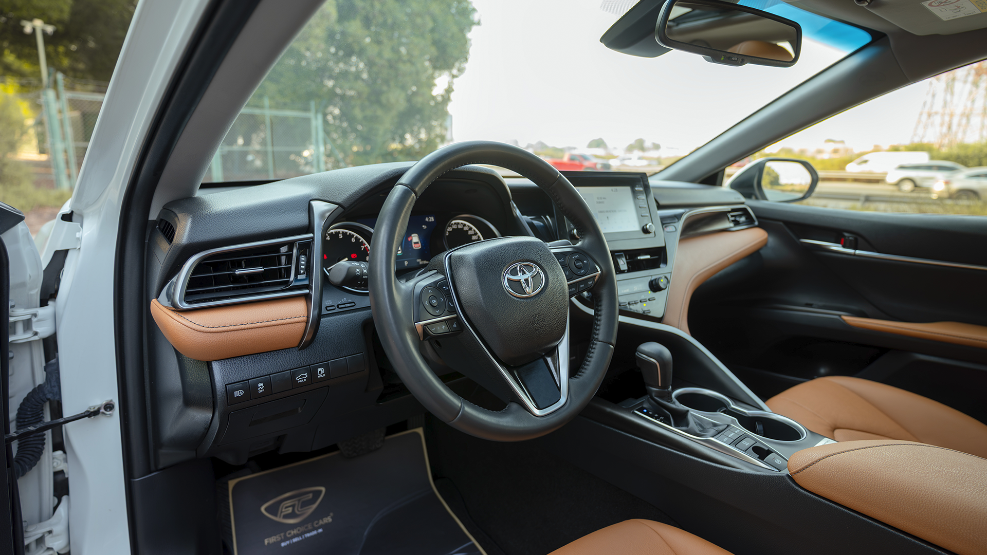 Used 2023 Toyota Camry 40th Anniversary in White – Driver Side Dashboard & Steering View for Sale at First Choice Cars Dubai Sharjah
