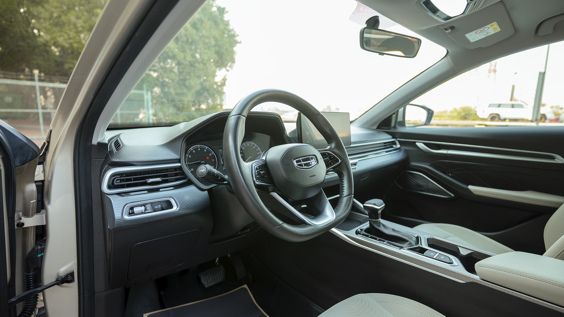Used 2024 Geely Emgrand GS in Gold – Driver Side Dashboard & Steering View for Sale at First Choice Cars Dubai Sharjah