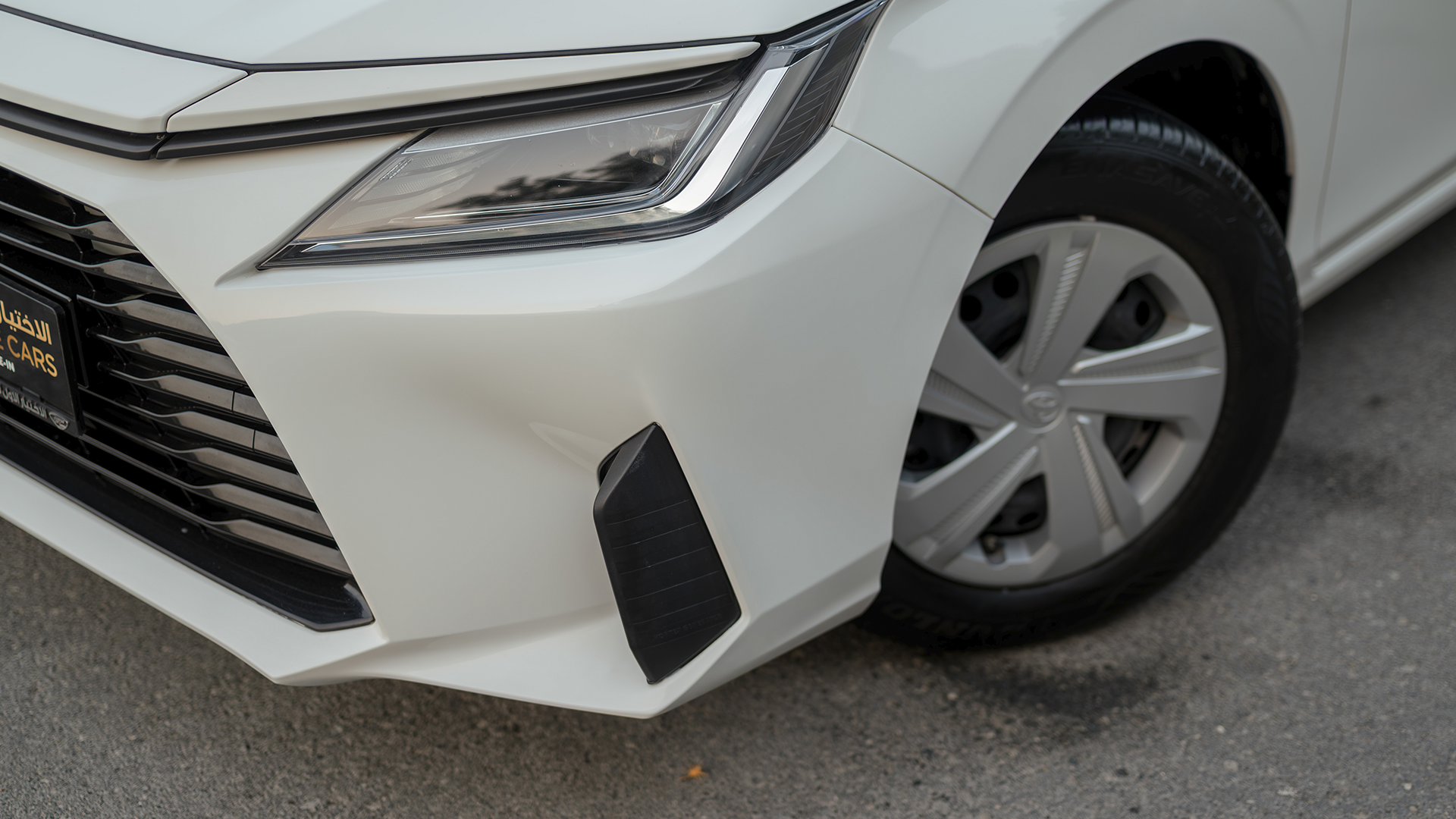 Used 2024 Toyota Yaris E in White – Headlight Close-up for Sale at First Choice Cars Dubai Sharjah