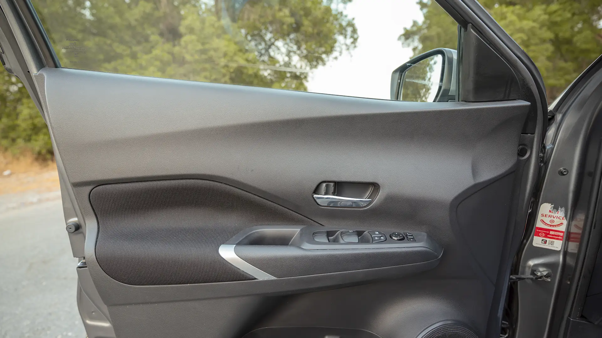 Used 2024 Nissan Kicks SV in Grey – Driver Door Panel Full View