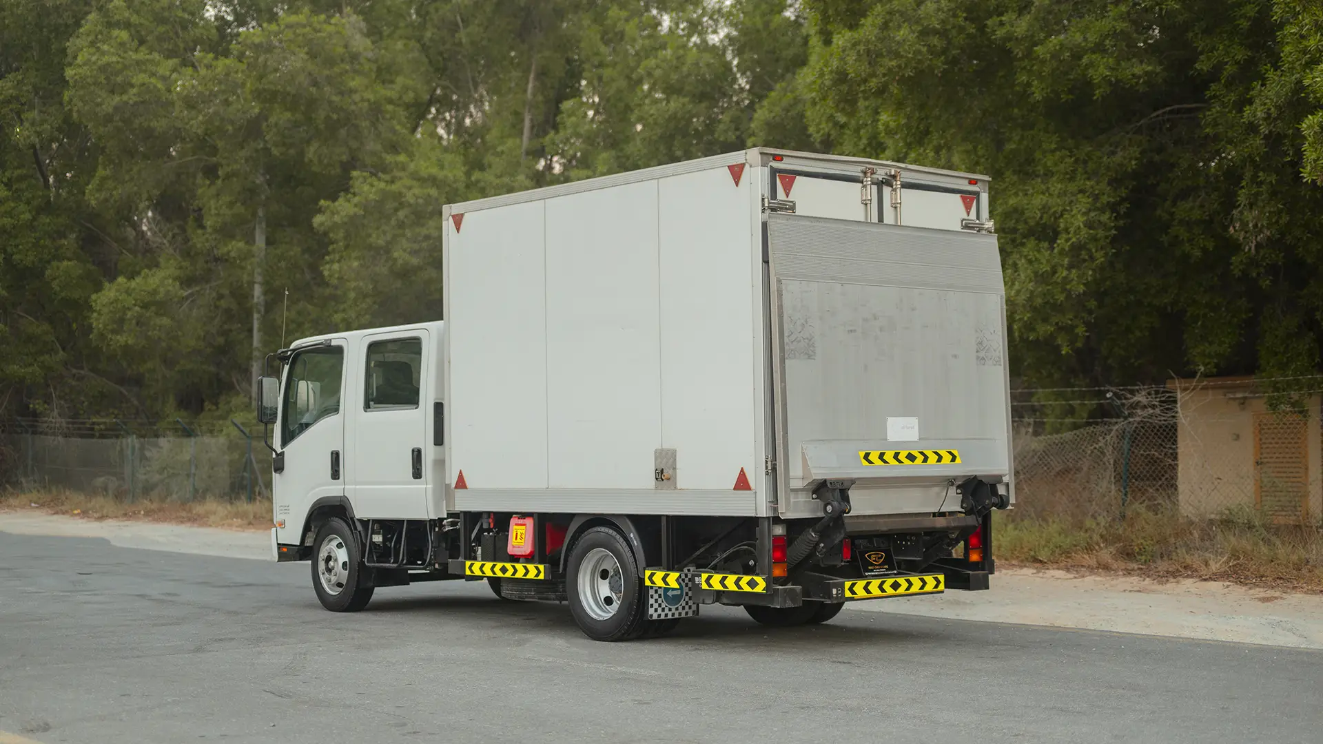 Used 2022 Isuzu NPR Double Cabin Cargo Box in White – Left Back Diagonal (45°) View