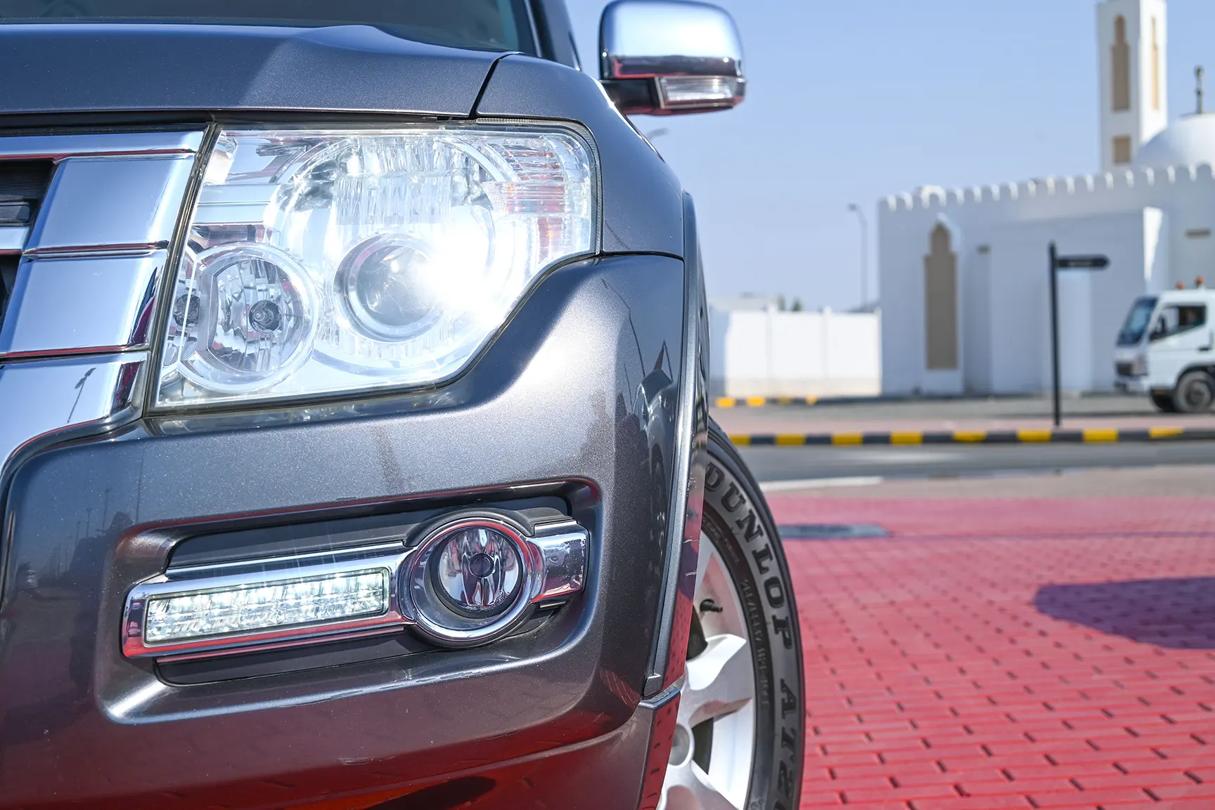 Used 2017 Mitsubishi PAJERO 3.5L GLS Silver – Headlight Close-up at First Choice Cars Sharjah